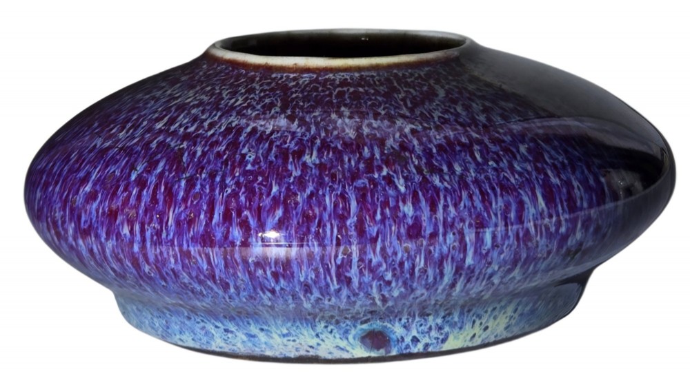 A compressed circular Chinese porcelain brush washer featuring a mottled purple and lavender blue flambe glaze. View III