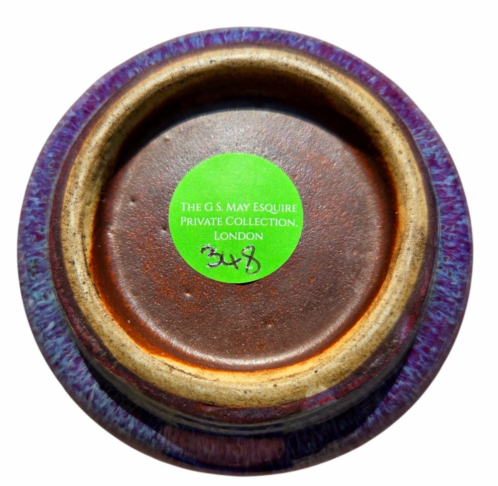 A compressed circular Chinese porcelain brush washer featuring a mottled purple and lavender blue flambe glaze. View IV