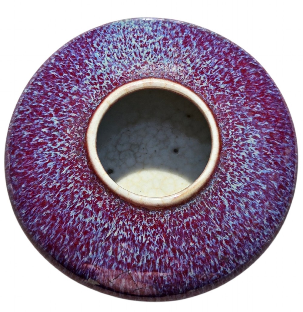 A compressed circular Chinese porcelain brush washer featuring a mottled purple and lavender blue flambe glaze. View V