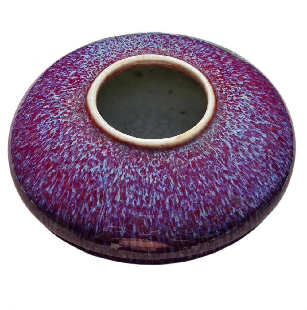 A compressed circular Chinese porcelain brush washer featuring a mottled purple and lavender blue flambe glaze. View VI