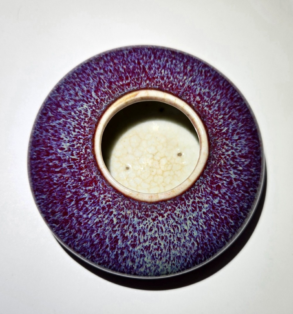A compressed circular Chinese porcelain brush washer featuring a mottled purple and lavender blue flambe glaze. View VIII