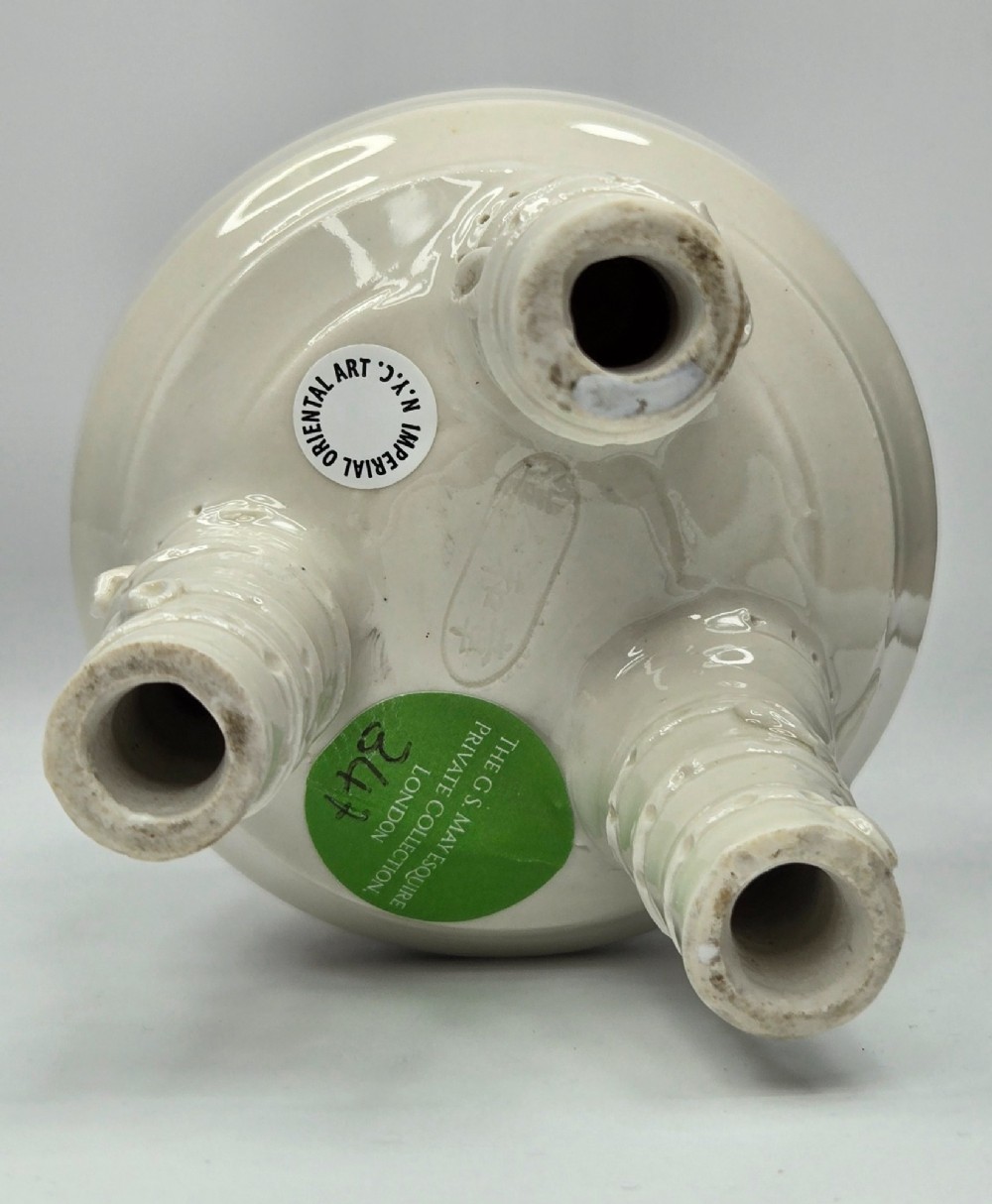 An off-white porcelain tripod censer featuring bamboo-node shaped legs, elevated loop handles, and subtle horizontal ridges across the body. View VII
