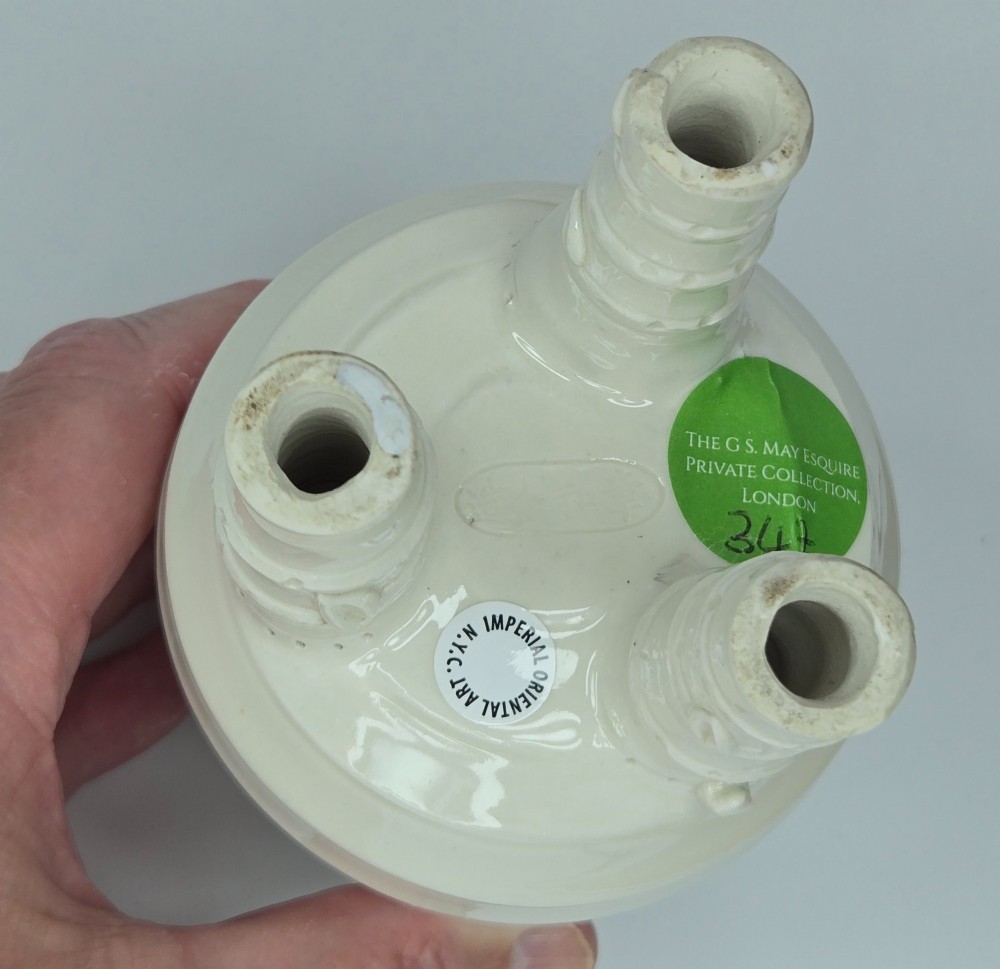 An off-white porcelain tripod censer featuring bamboo-node shaped legs, elevated loop handles, and subtle horizontal ridges across the body. View VIII