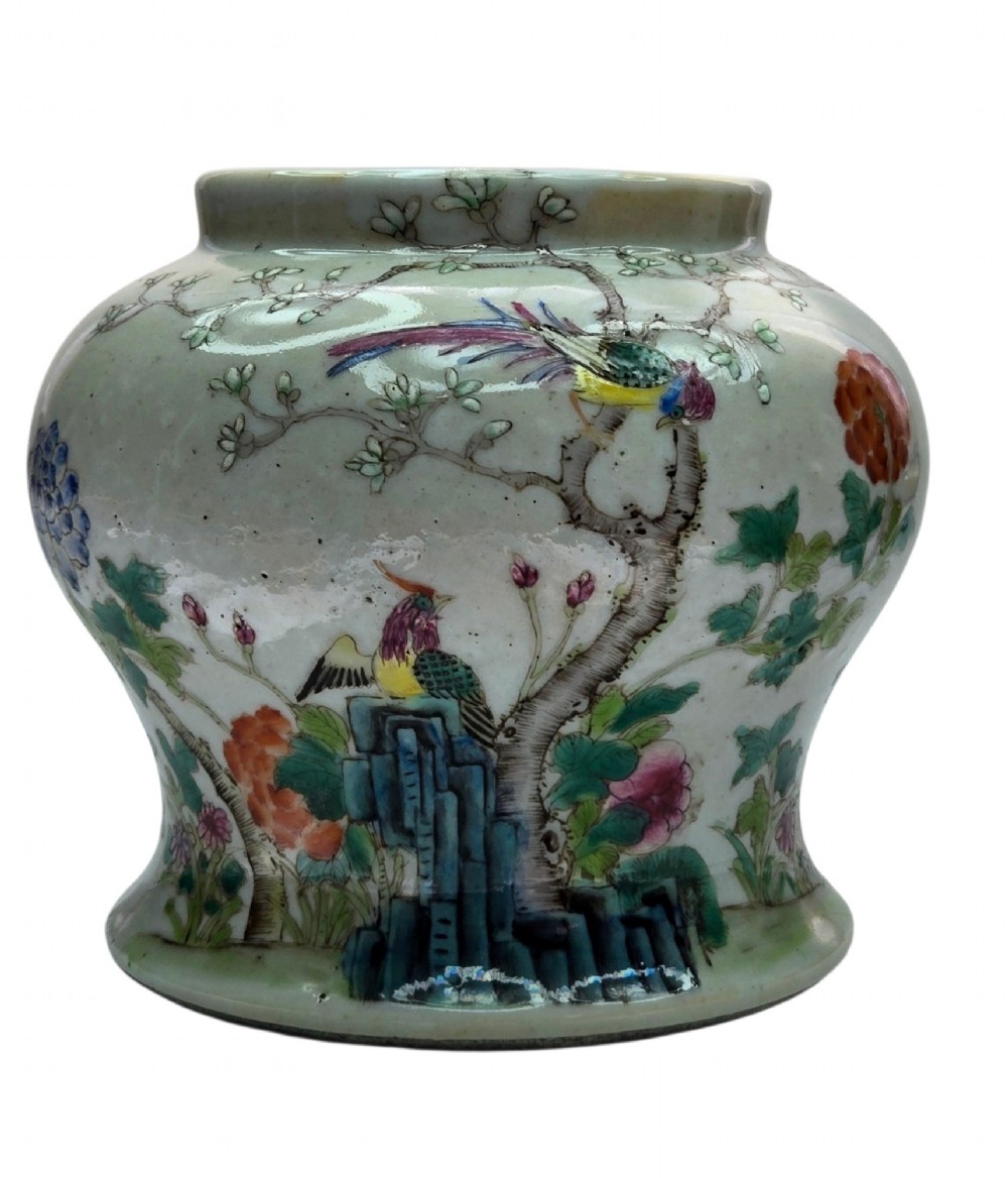 A Chinese Famille Rose porcelain jar decorated with hand-painted birds, flowers, and rockwork against a white ground. View II