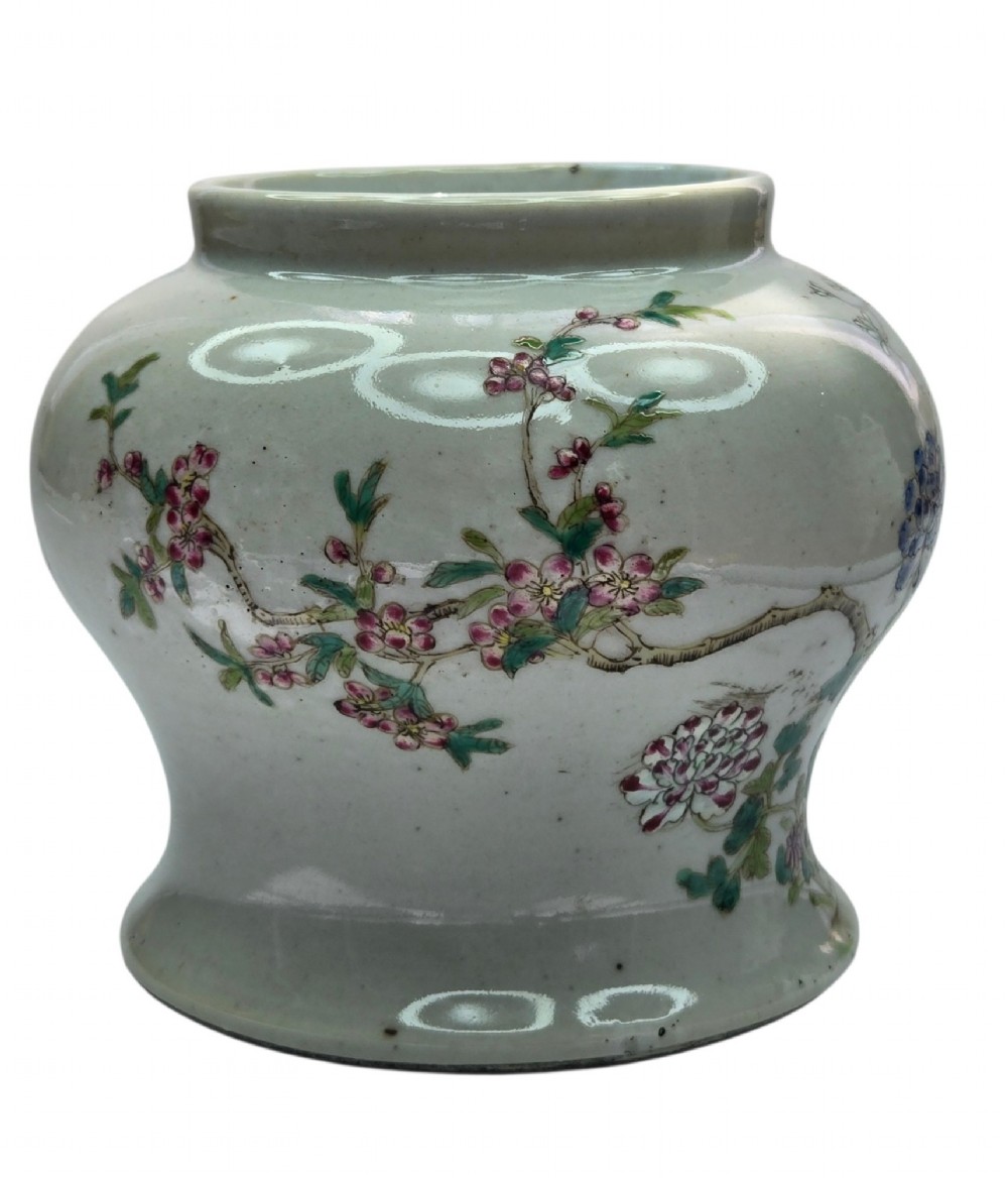 A Chinese Famille Rose porcelain jar decorated with hand-painted birds, flowers, and rockwork against a white ground. View V