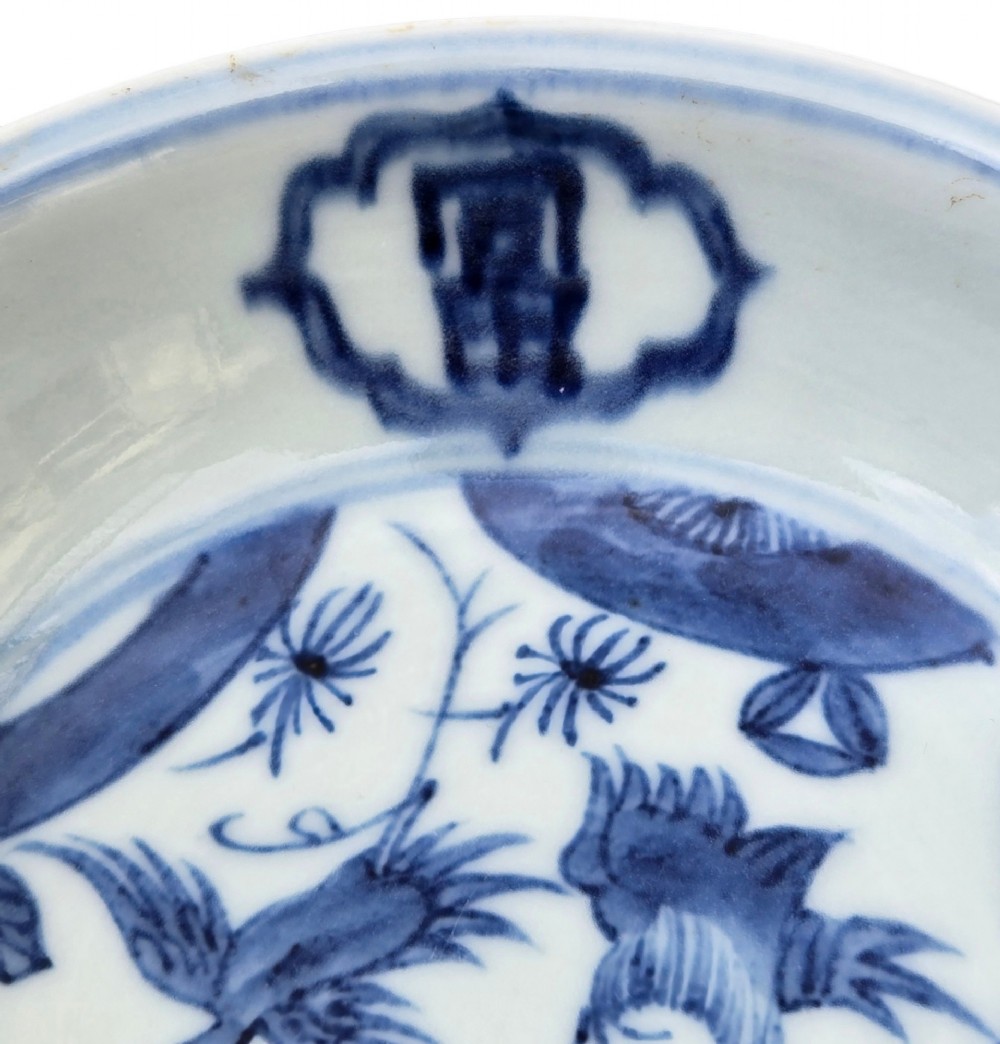 A circular Chinese blue and white porcelain deep saucer dish decorated with cobalt underglaze imagery of Shoulao, a crane, and character cartouches. View III