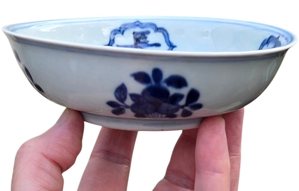 A circular Chinese blue and white porcelain deep saucer dish decorated with cobalt underglaze imagery of Shoulao, a crane, and character cartouches. View X