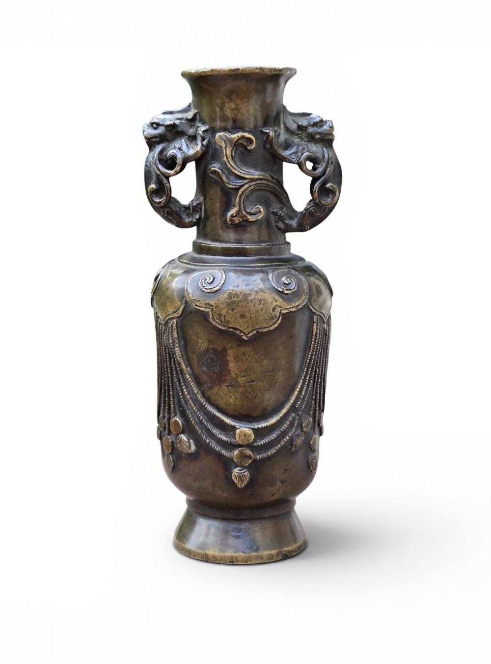 A patinated cast bronze Chinese vase featuring stylised dragon-head handles and raised Yingluo beaded tassels.