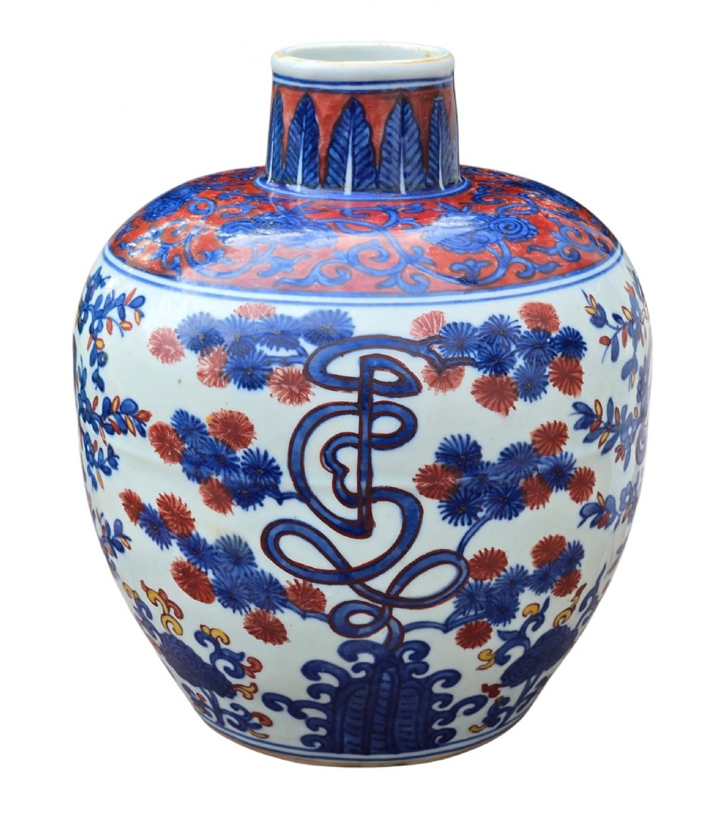 An antique Chinese porcelain jar decorated with underglaze blue and iron-red motifs, featuring plantain leaves and a central longevity symbol. View III