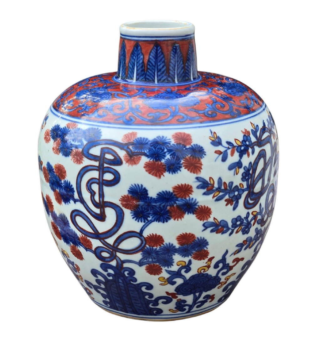 An antique Chinese porcelain jar decorated with underglaze blue and iron-red motifs, featuring plantain leaves and a central longevity symbol. View IV