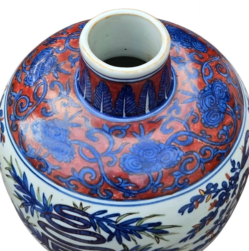 An antique Chinese porcelain jar decorated with underglaze blue and iron-red motifs, featuring plantain leaves and a central longevity symbol. View VIII