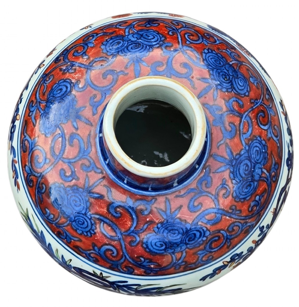 An antique Chinese porcelain jar decorated with underglaze blue and iron-red motifs, featuring plantain leaves and a central longevity symbol. View IX