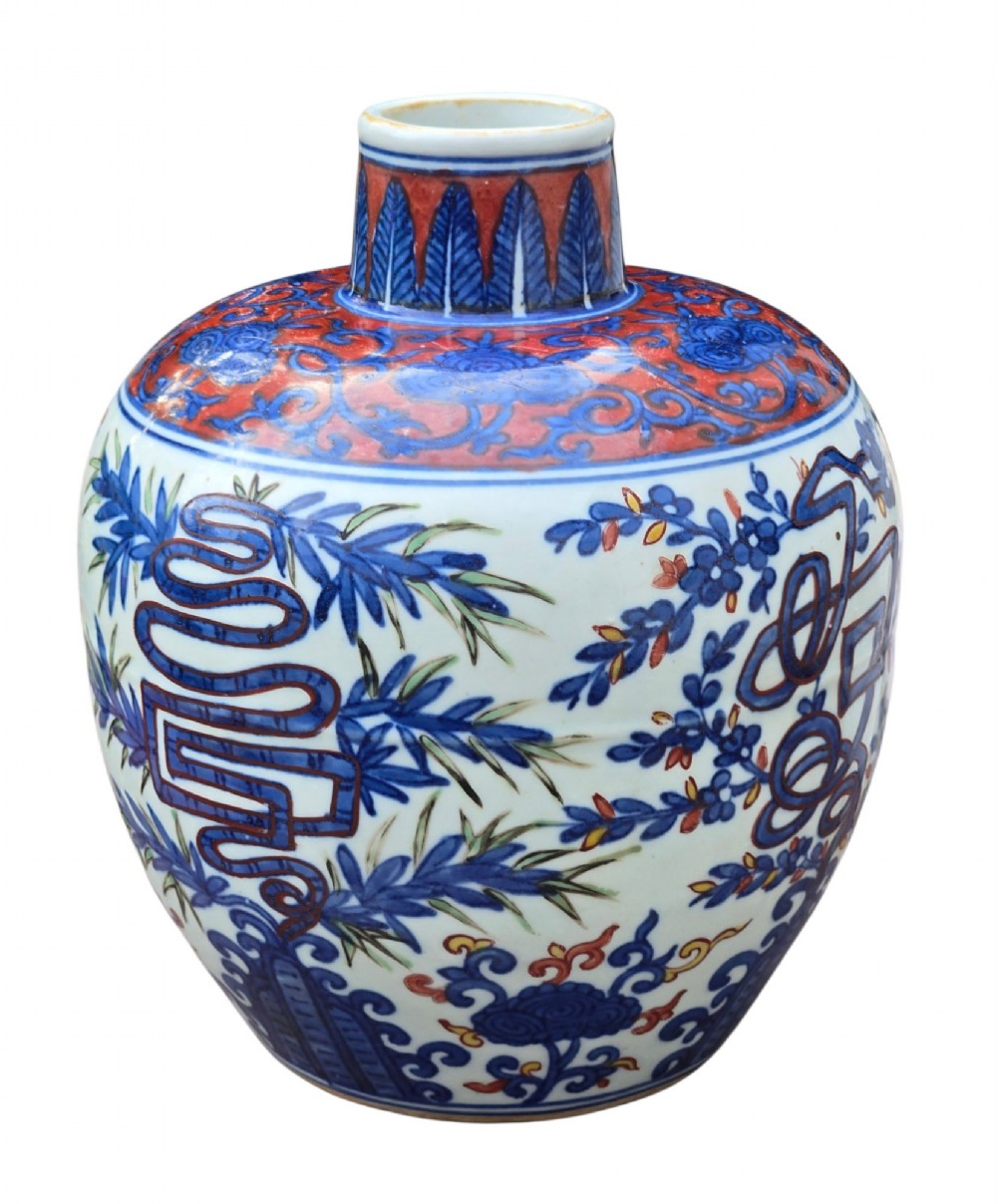 An antique Chinese porcelain jar decorated with underglaze blue and iron-red motifs, featuring plantain leaves and a central longevity symbol. View XI