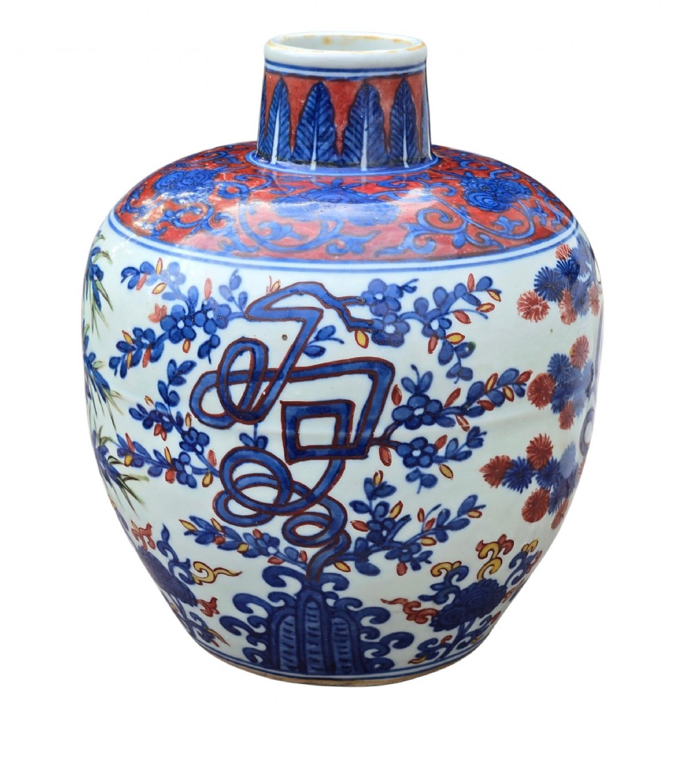 An antique Chinese porcelain jar decorated with underglaze blue and iron-red motifs, featuring plantain leaves and a central longevity symbol. View XII