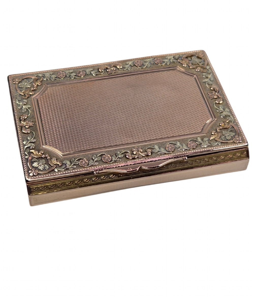 A rectangular 18K gold snuff box featuring engine-turned panels and chased floral relief borders in multi-toned gold. View II
