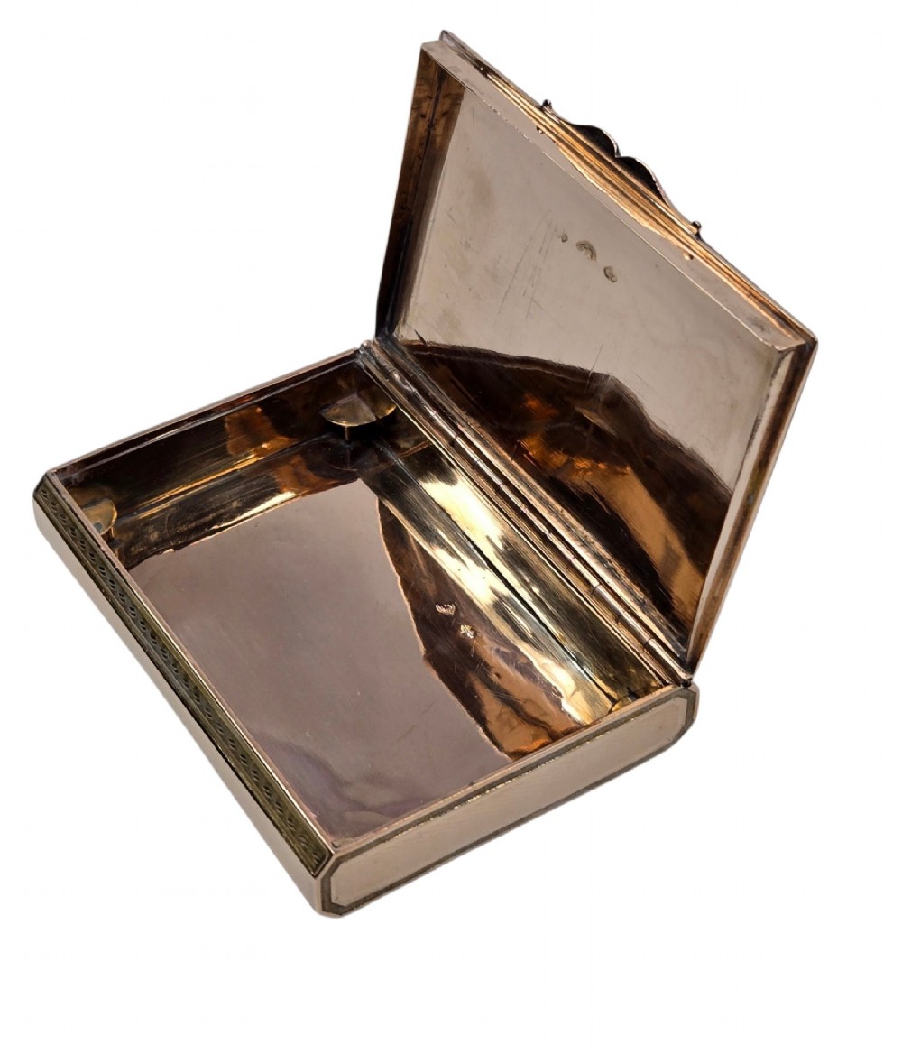 A rectangular 18K gold snuff box featuring engine-turned panels and chased floral relief borders in multi-toned gold. View IV