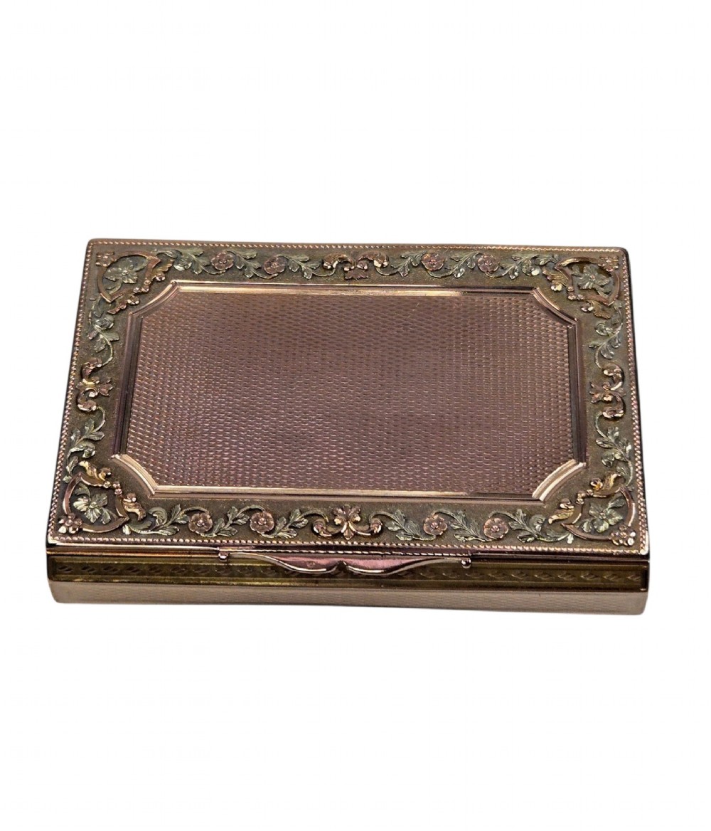 A rectangular 18K gold snuff box featuring engine-turned panels and chased floral relief borders in multi-toned gold. View VI