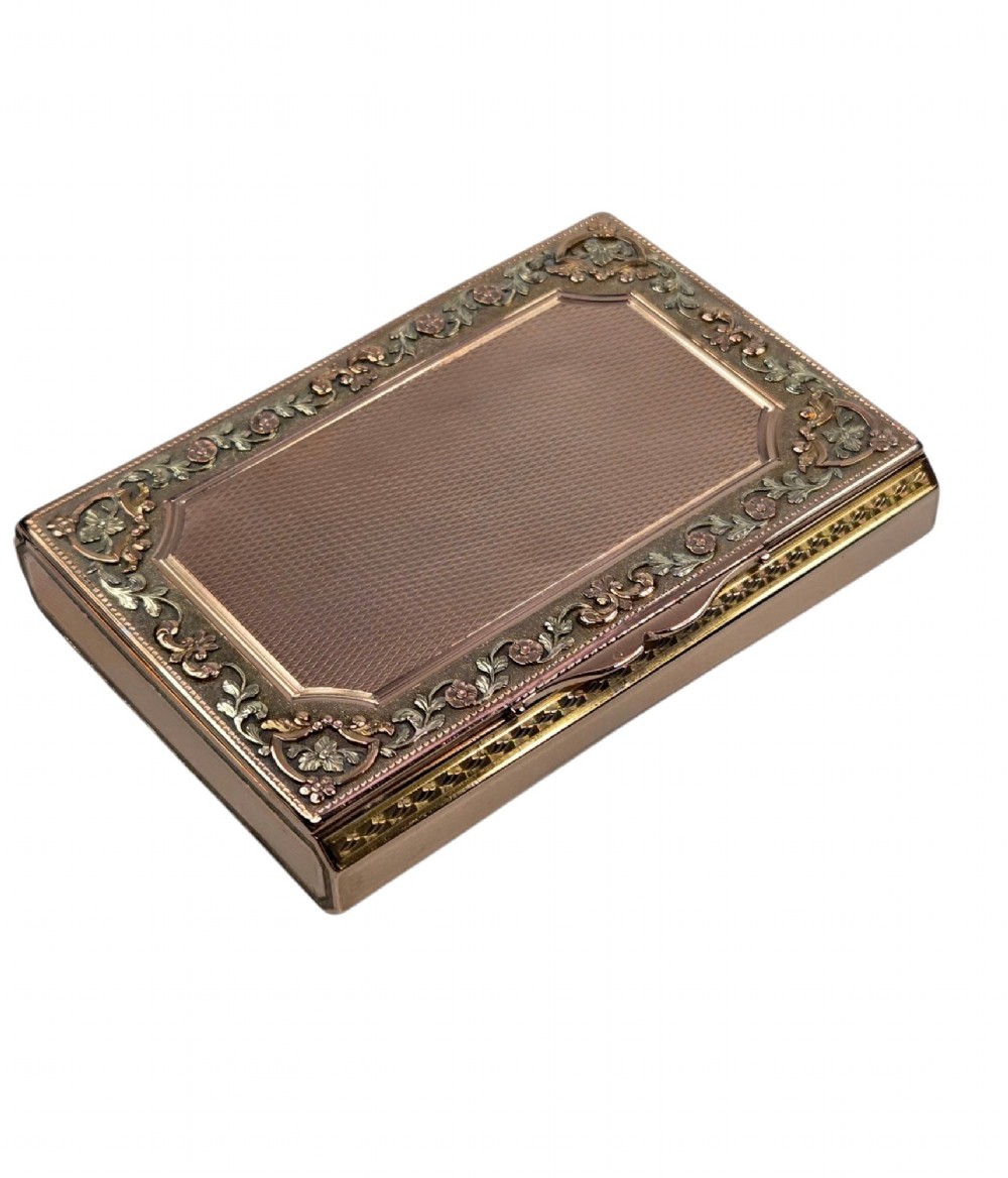 A rectangular 18K gold snuff box featuring engine-turned panels and chased floral relief borders in multi-toned gold. View VII