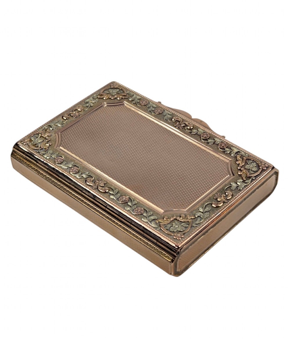 A rectangular 18K gold snuff box featuring engine-turned panels and chased floral relief borders in multi-toned gold. View VIII