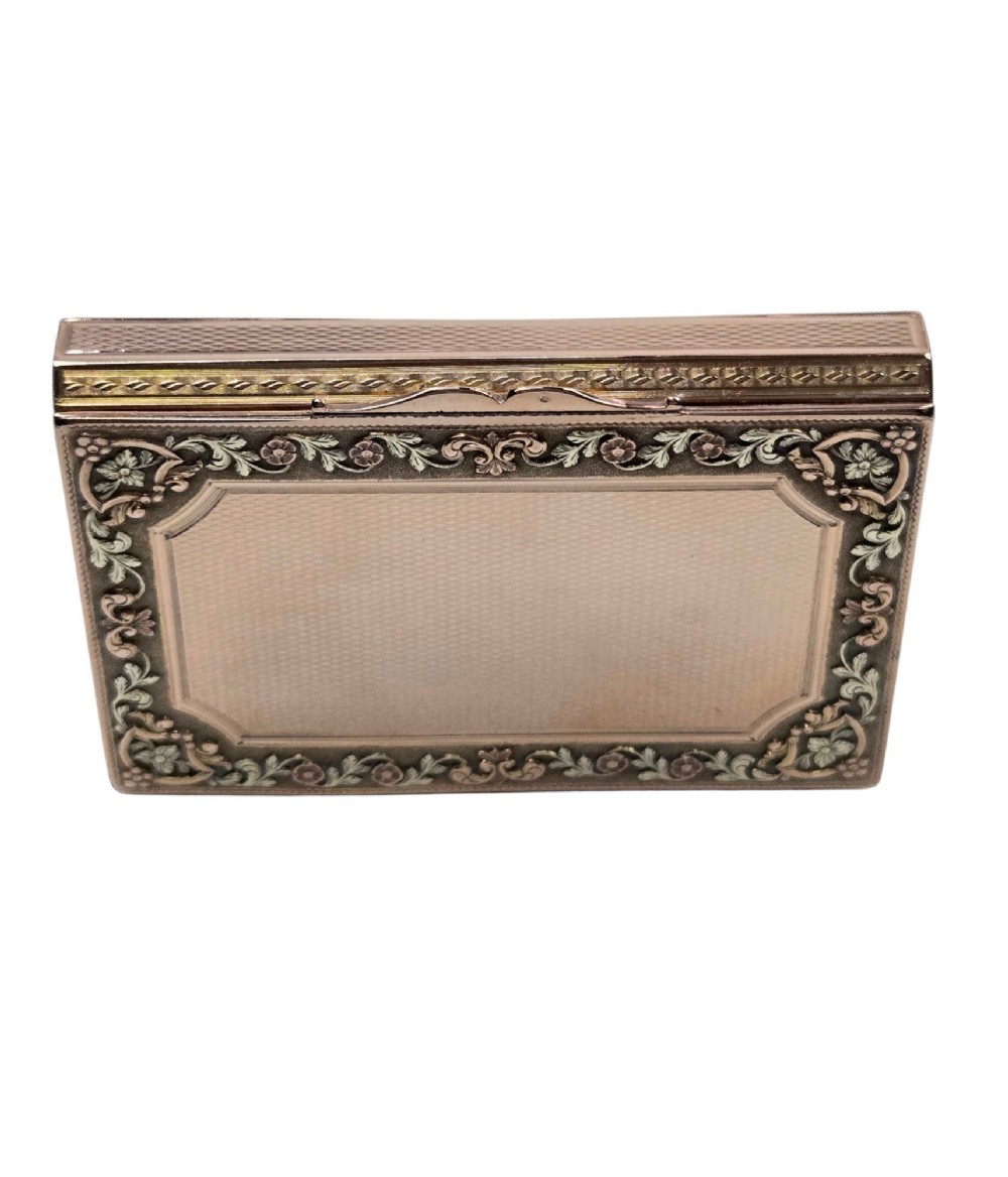 A rectangular 18K gold snuff box featuring engine-turned panels and chased floral relief borders in multi-toned gold. View X