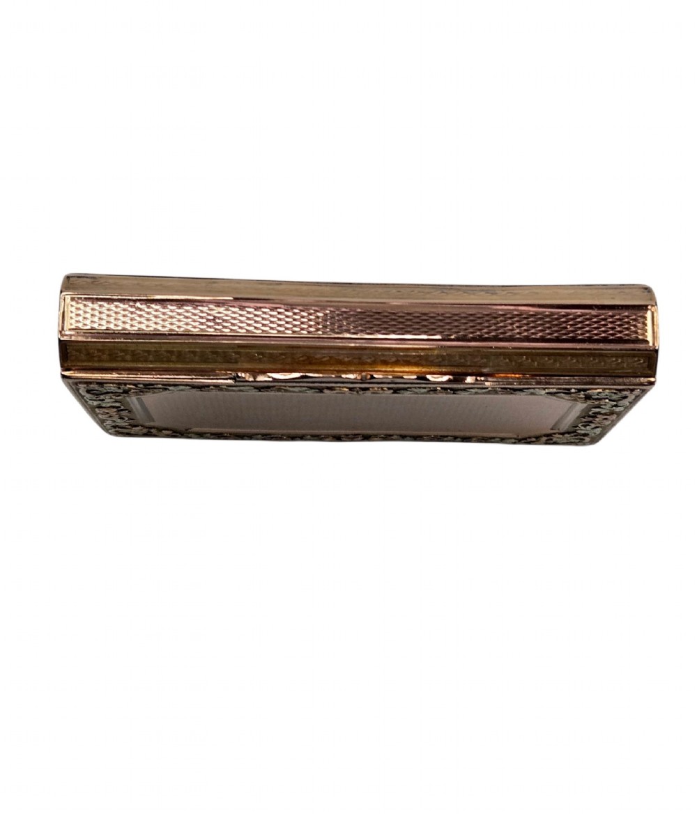 A rectangular 18K gold snuff box featuring engine-turned panels and chased floral relief borders in multi-toned gold. View XI