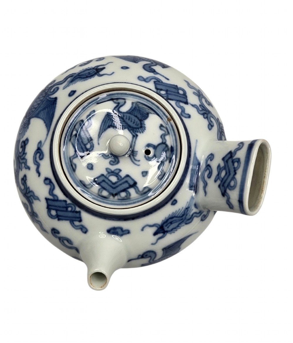 A Japanese porcelain side-handled teapot featuring hand-painted cobalt blue motifs against a white background. View III
