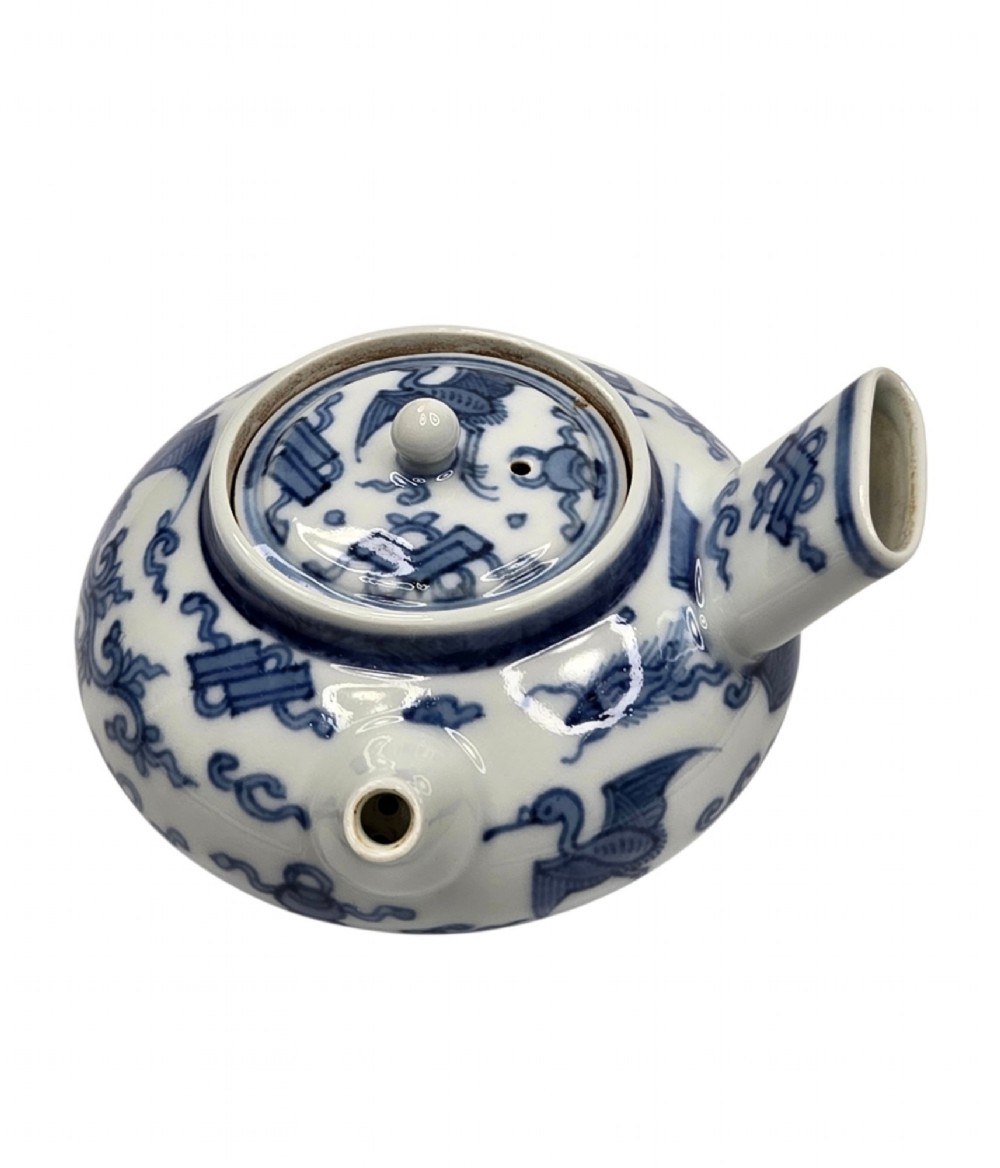A Japanese porcelain side-handled teapot featuring hand-painted cobalt blue motifs against a white background. View IV