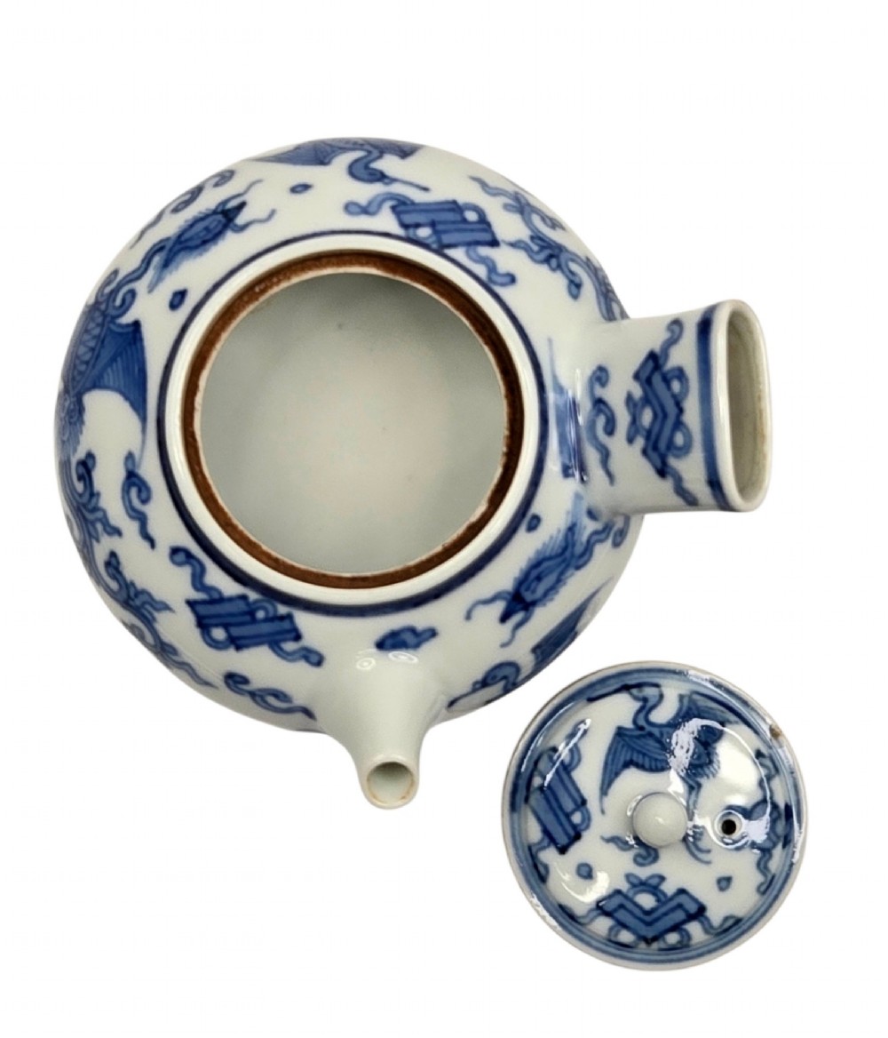 A Japanese porcelain side-handled teapot featuring hand-painted cobalt blue motifs against a white background. View V
