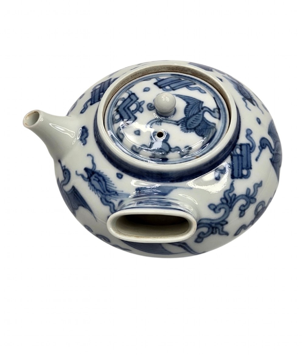 A Japanese porcelain side-handled teapot featuring hand-painted cobalt blue motifs against a white background. View VI
