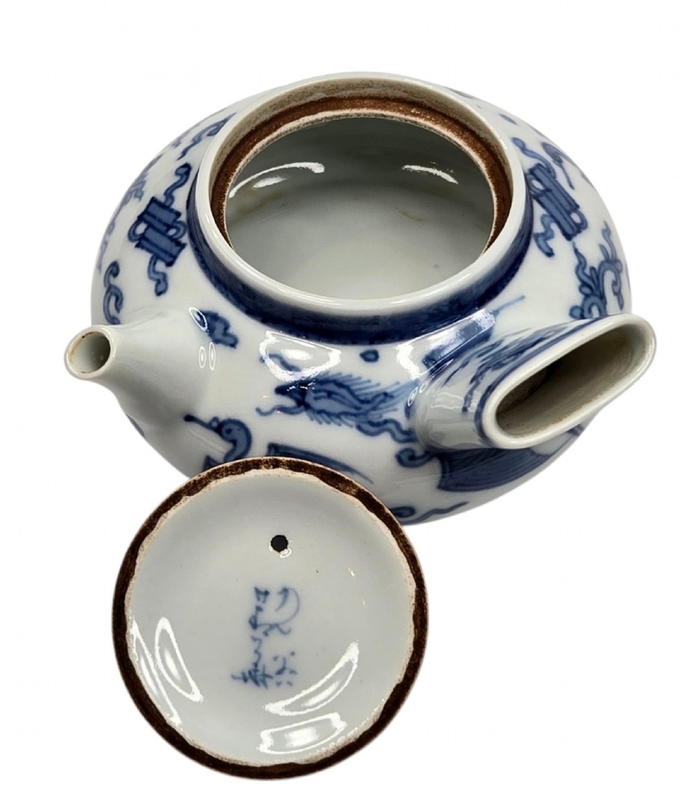 A Japanese porcelain side-handled teapot featuring hand-painted cobalt blue motifs against a white background. View VII