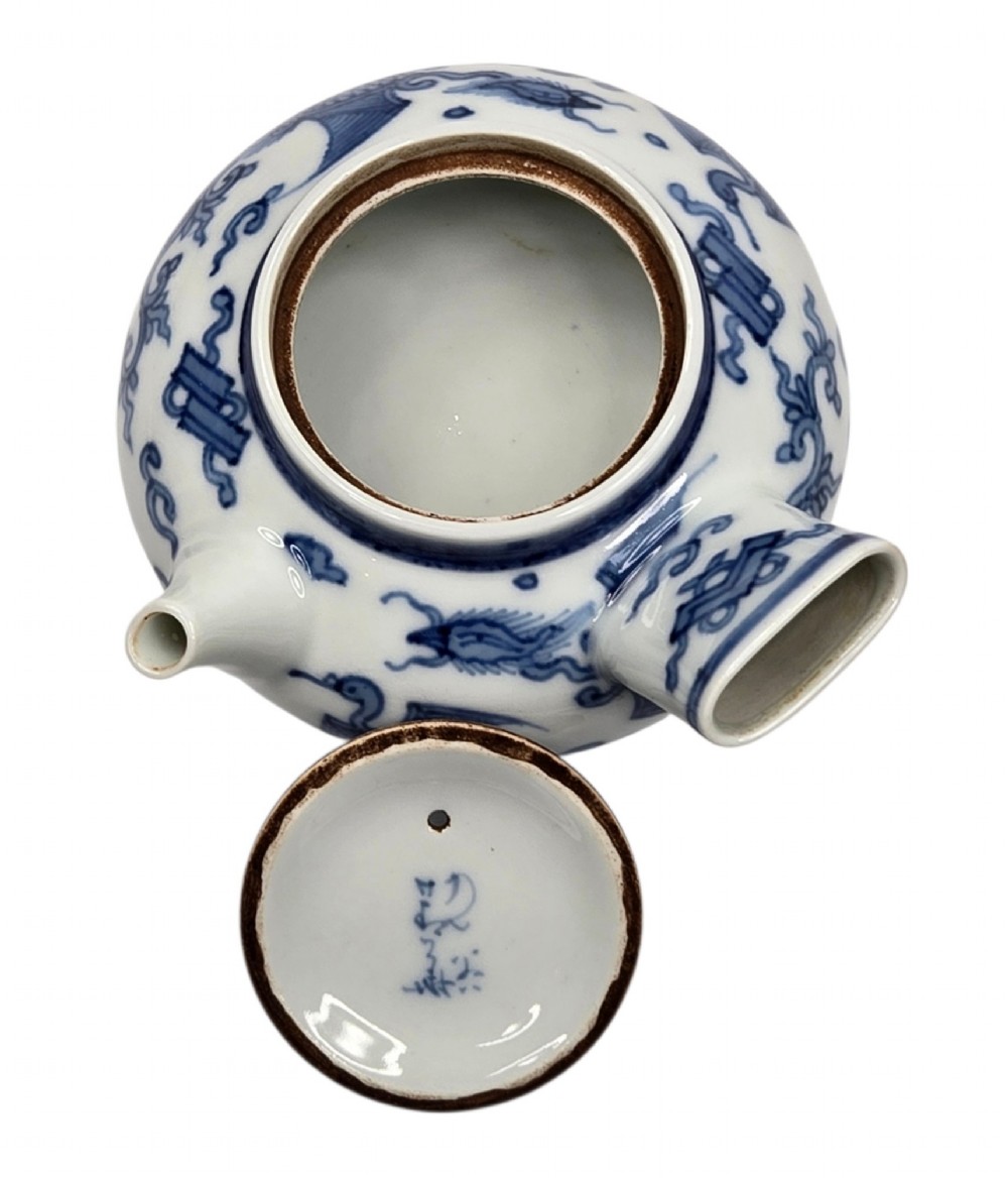 A Japanese porcelain side-handled teapot featuring hand-painted cobalt blue motifs against a white background. View VIII