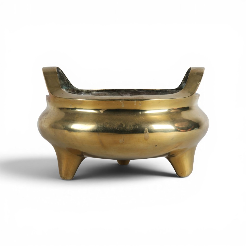 A heavy gold-toned cast bronze tripod censer featuring two upright loop handles and conical feet. View II