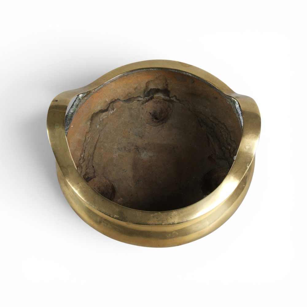 A heavy gold-toned cast bronze tripod censer featuring two upright loop handles and conical feet. View IV