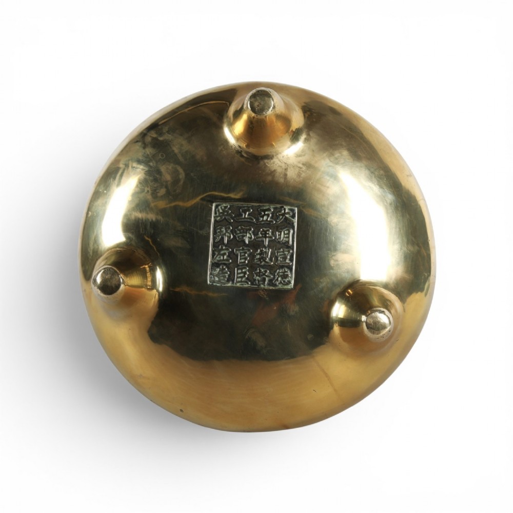 A heavy gold-toned cast bronze tripod censer featuring two upright loop handles and conical feet. View VI