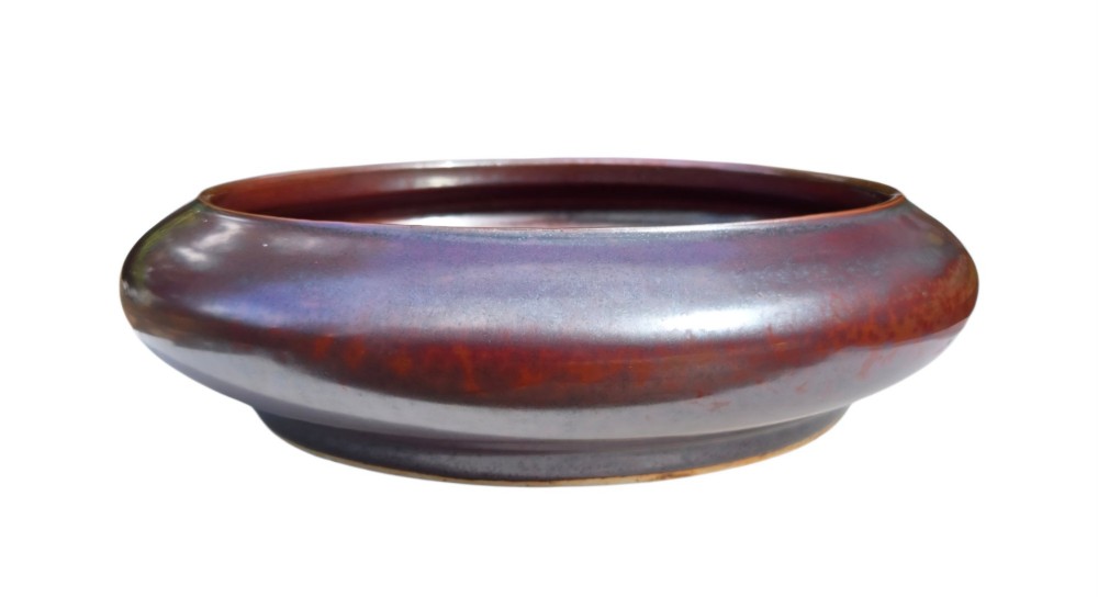 A low compressed circular ceramic brush washer featuring a dark reddish-brown iron rust glaze with subtle metallic speckling. View VII