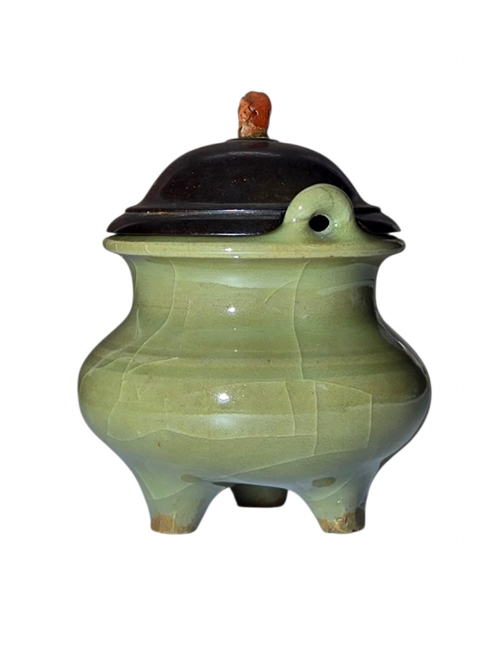 A miniature pale celadon green tripod censer with a distinct crackle glaze, fitted with a dark wood cover and a carved red coral finial. View III
