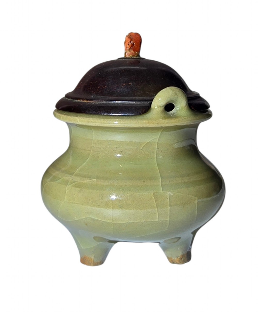 A miniature pale celadon green tripod censer with a distinct crackle glaze, fitted with a dark wood cover and a carved red coral finial. View IV