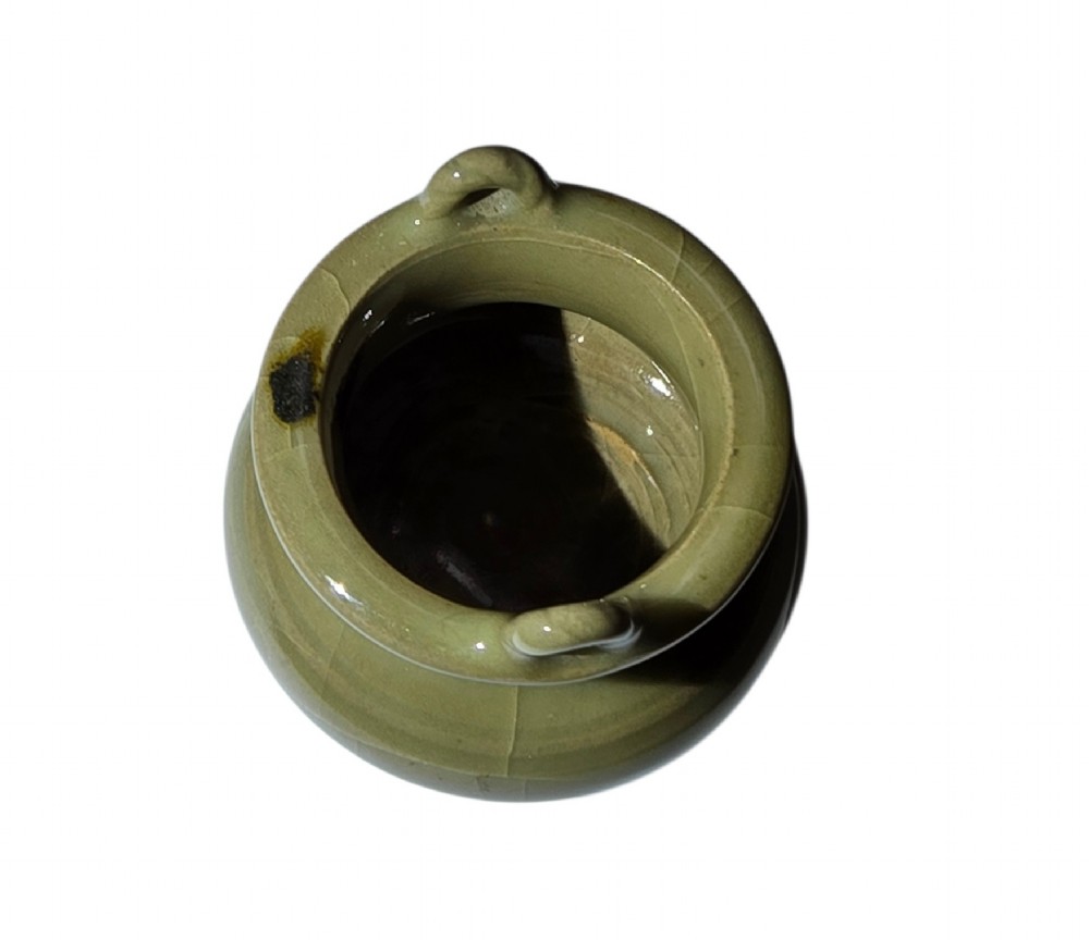 A miniature pale celadon green tripod censer with a distinct crackle glaze, fitted with a dark wood cover and a carved red coral finial. View VII