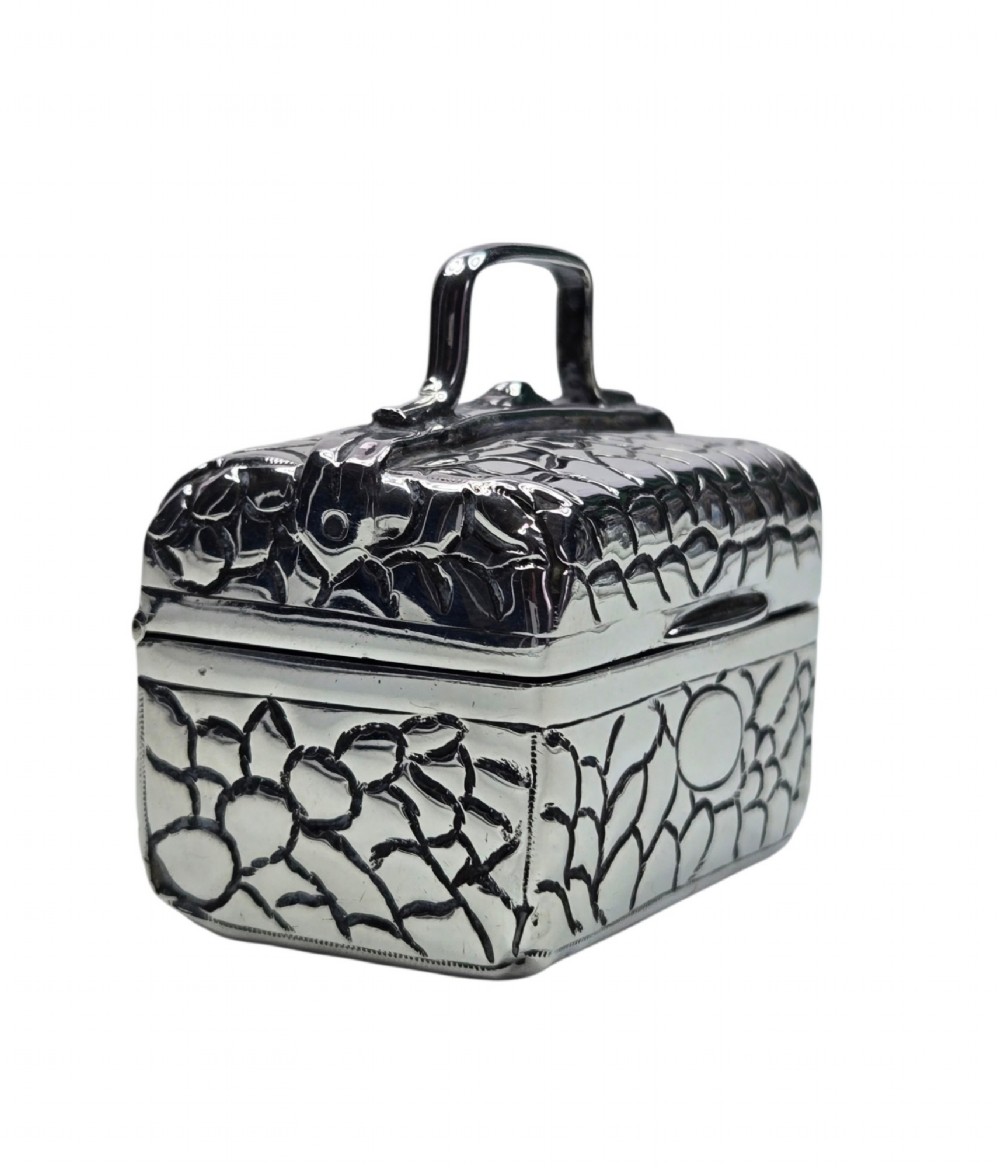 A late Victorian sterling silver novelty box crafted in the form of a miniature trunk with embossed crocodile skin texture and a top carrying handle. View VII