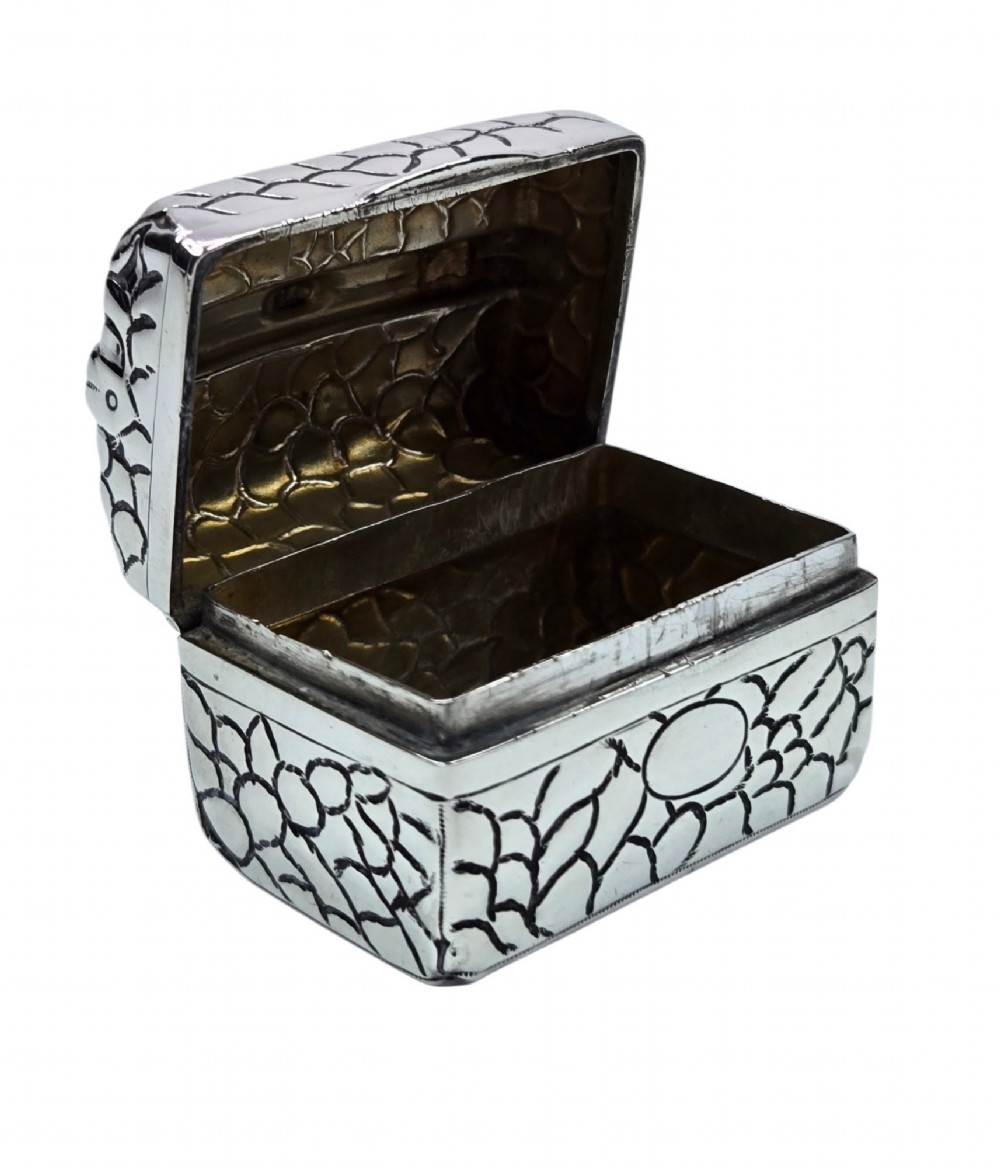 A late Victorian sterling silver novelty box crafted in the form of a miniature trunk with embossed crocodile skin texture and a top carrying handle. View VIII