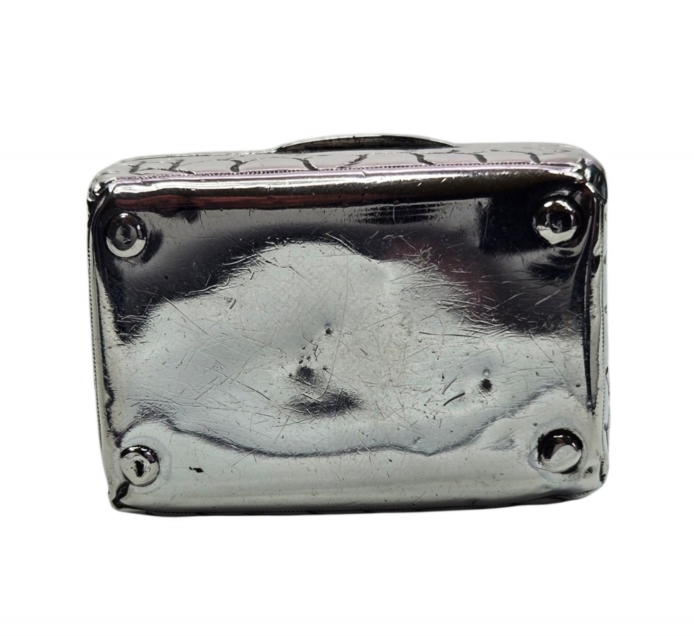 A late Victorian sterling silver novelty box crafted in the form of a miniature trunk with embossed crocodile skin texture and a top carrying handle. View IX