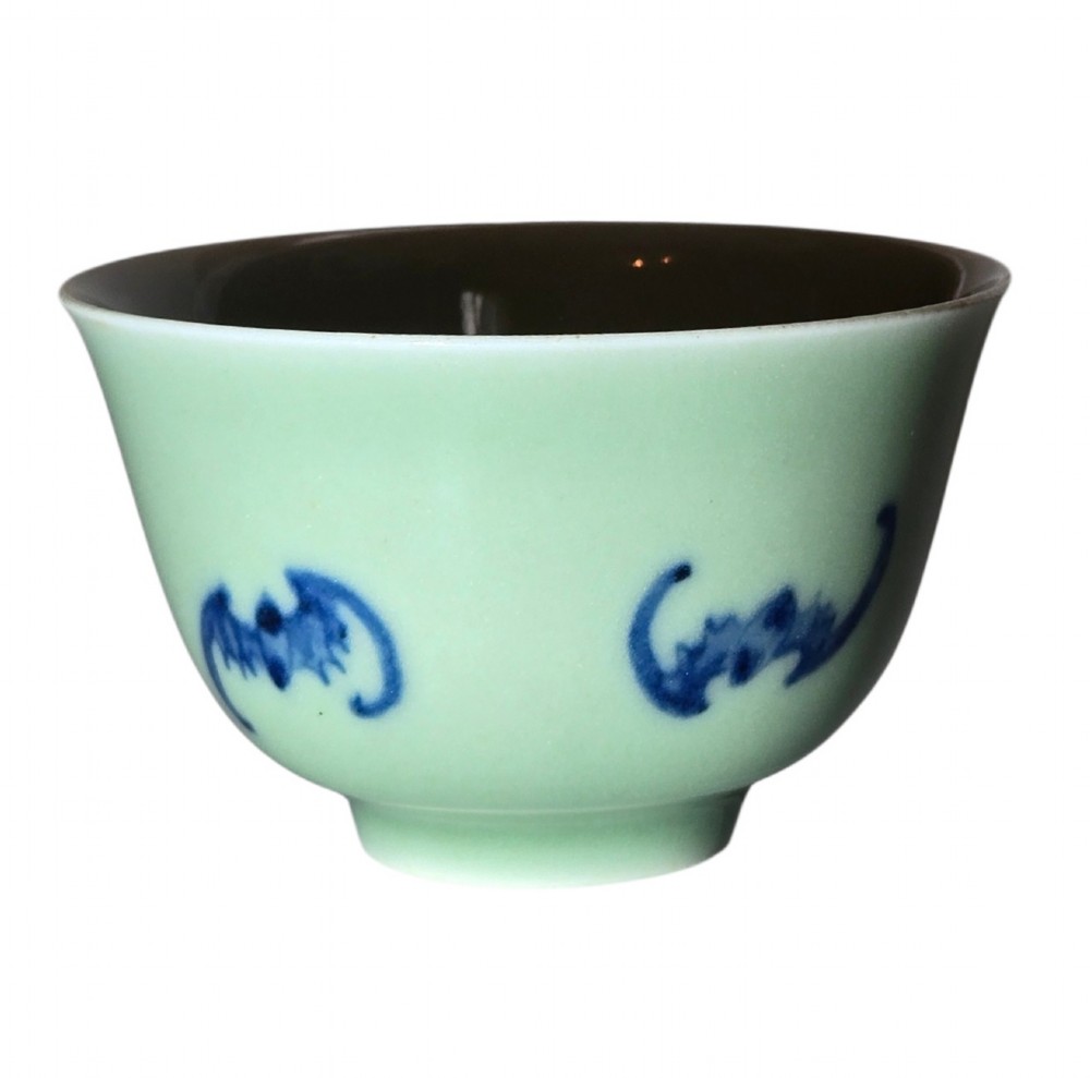 A small Chinese celadon green glazed porcelain cup decorated with underglaze blue bat motifs around the exterior. View III