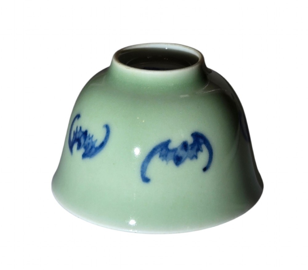 A small Chinese celadon green glazed porcelain cup decorated with underglaze blue bat motifs around the exterior. View VIII