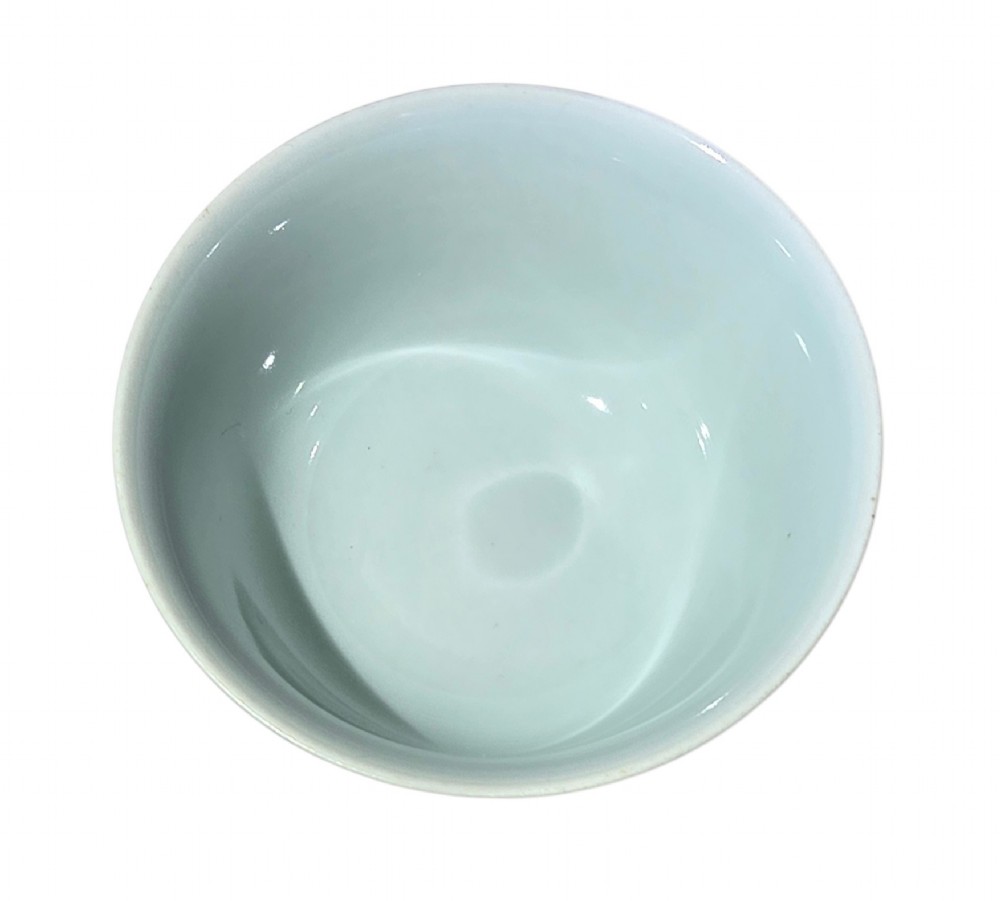 A small Chinese celadon green glazed porcelain cup decorated with underglaze blue bat motifs around the exterior. View XII