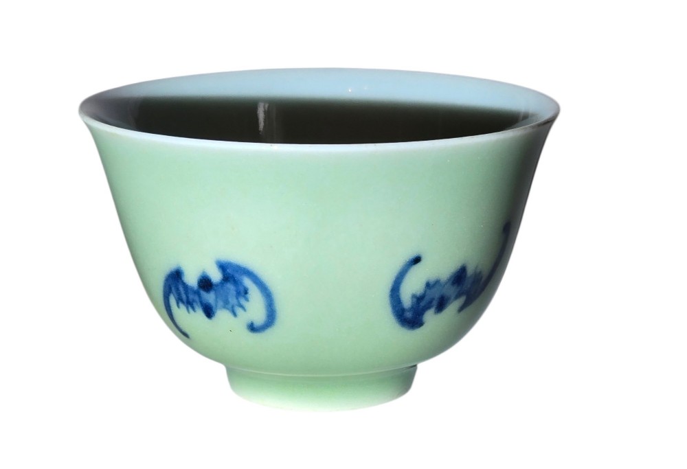 A small Chinese celadon green glazed porcelain cup decorated with underglaze blue bat motifs around the exterior. View XIII