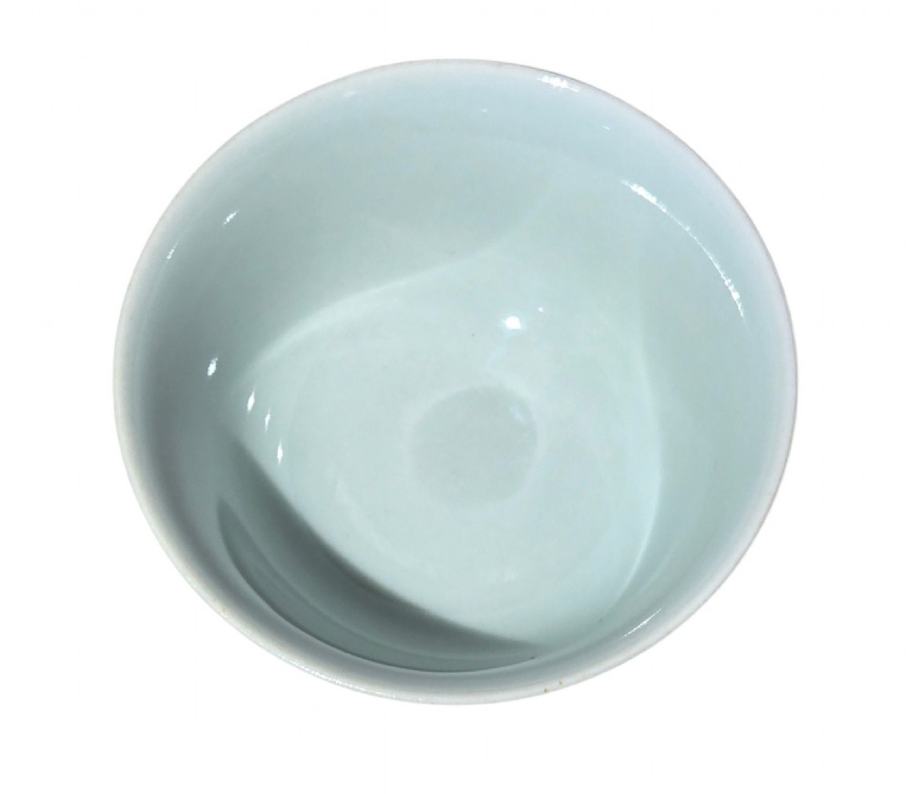 A small Chinese celadon green glazed porcelain cup decorated with underglaze blue bat motifs around the exterior. View XIV