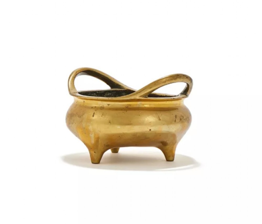 A heavy cast golden brass tripod censer featuring loop handles and three tapered feet. View II