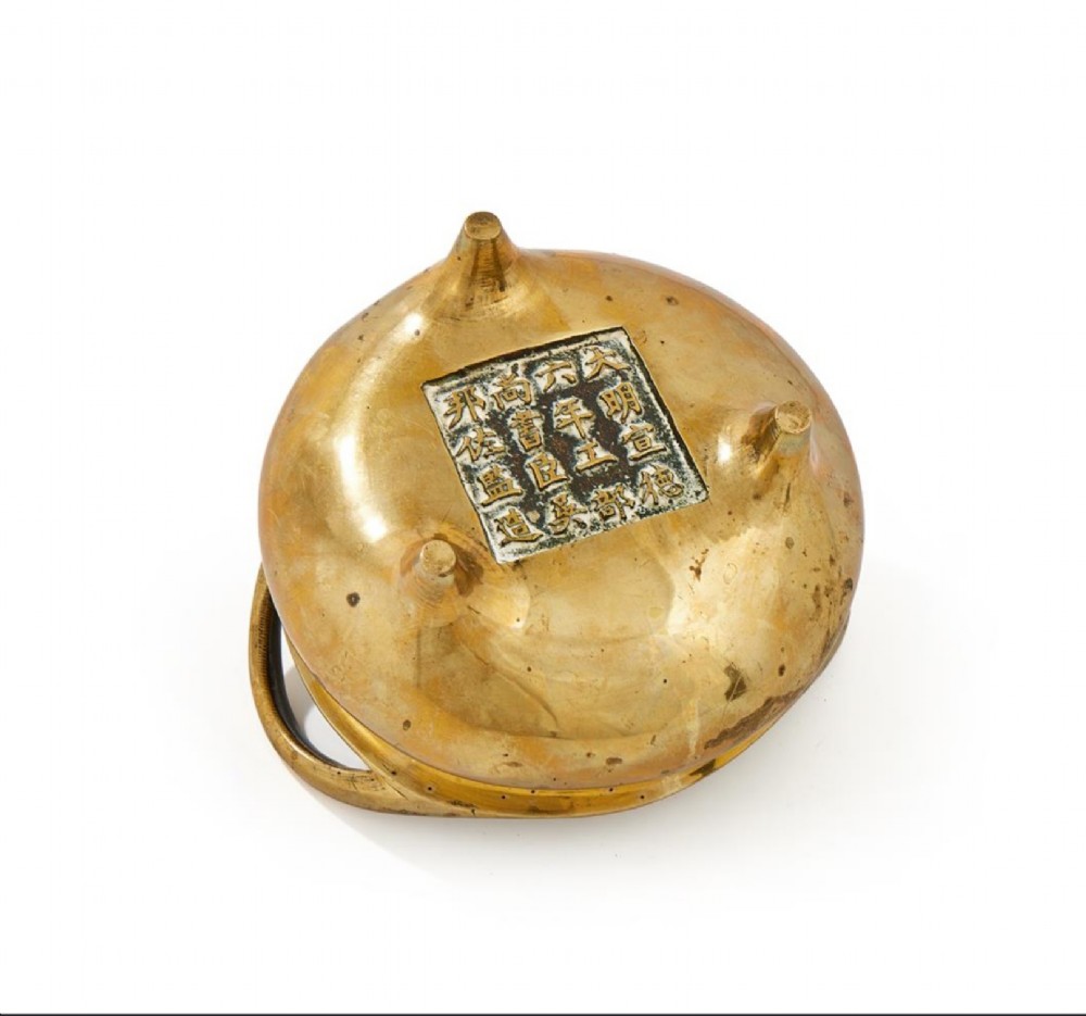 A heavy cast golden brass tripod censer featuring loop handles and three tapered feet. View III