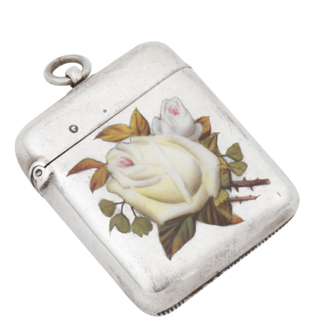A rectangular sterling silver vesta case featuring hand-painted yellow and white roses in enamel with a top suspension loop. View V
