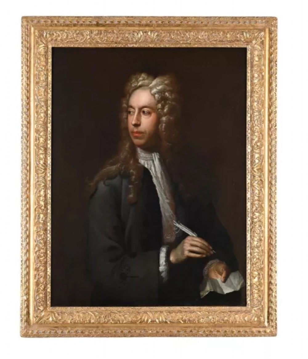 An eighteenth-century oil painting depicting a gentleman scholar with a long wig and quill pen, set within an ornate gilded frame.